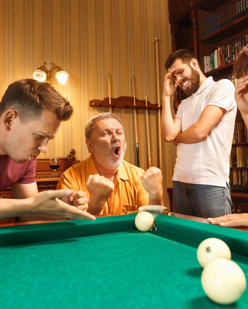 The displeased men playing billiards at office or home after work. Business colleagues involving in recreational activity. Friendship, leisure activity, game concept. Human emotions concepts